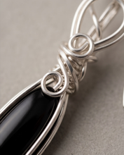 Load image into Gallery viewer,     Black Onyx gemstone earrings in sterling silver displayed on cream fabric