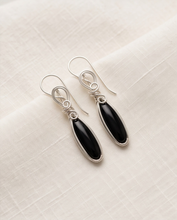 Load image into Gallery viewer,     Black Onyx gemstone earrings in sterling silver displayed on cream fabric