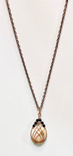 Load image into Gallery viewer, This handmade Scolecite pendant is wrapped in warm copper and accented with faceted black Onyx beads for bold contrast. A one-of-a-kind gemstone necklace combining peace and strength.
