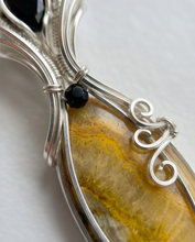Load image into Gallery viewer, handcrafted golden bumblebee jasper pendant with soft yellow tones sterling silver wire wrap with scroll detail and gemstone accents