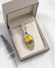 Load image into Gallery viewer, Handcrafted bumblebee jasper pendant in sterling silver with soft yellow and gray banding and elegant wire wrap design