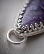 Load image into Gallery viewer, Purple Charoite pendant set in handcrafted sterling silver with decorative edging.
