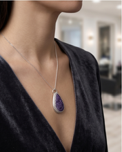 Load image into Gallery viewer, Purple Charoite pendant set in handcrafted sterling silver with decorative edging.
