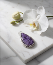 Load image into Gallery viewer, Purple Charoite pendant set in handcrafted sterling silver with decorative edging.
