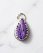Load image into Gallery viewer, Lifestyle image of handcrafted sterling silver Charoite teardrop pendant featuring natural lavender and violet gemstone patterns
