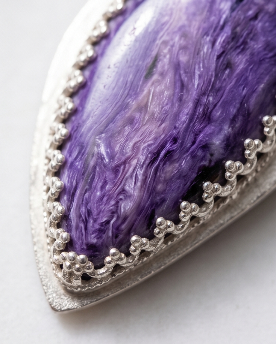 Lifestyle image of handcrafted sterling silver Charoite teardrop pendant featuring natural lavender and violet gemstone patterns
