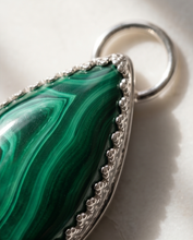 Load image into Gallery viewer, Lifestyle image of handcrafted sterling silver Malachite teardrop pendant worn on chain featuring natural green gemstone banding
