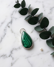 Load image into Gallery viewer, Lifestyle image of handcrafted sterling silver Malachite teardrop pendant worn on chain featuring natural green gemstone banding
