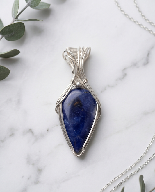 One-of-a-kind blue Sodalite pendant handcrafted in sterling silver with woven wire bail on chain