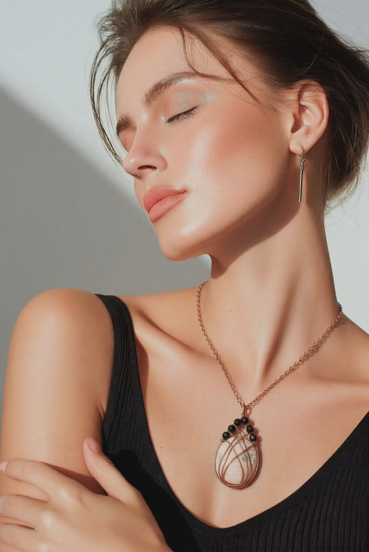 Handmade Scolecite pendant is wrapped in warm copper and accented with faceted black Onyx beads for bold contrast. A one-of-a-kind gemstone necklace combining peace and strength.